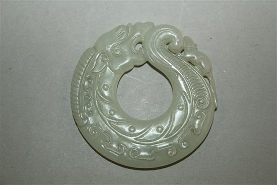 A Chinese archaistic white jade huang disc, 5.5cm